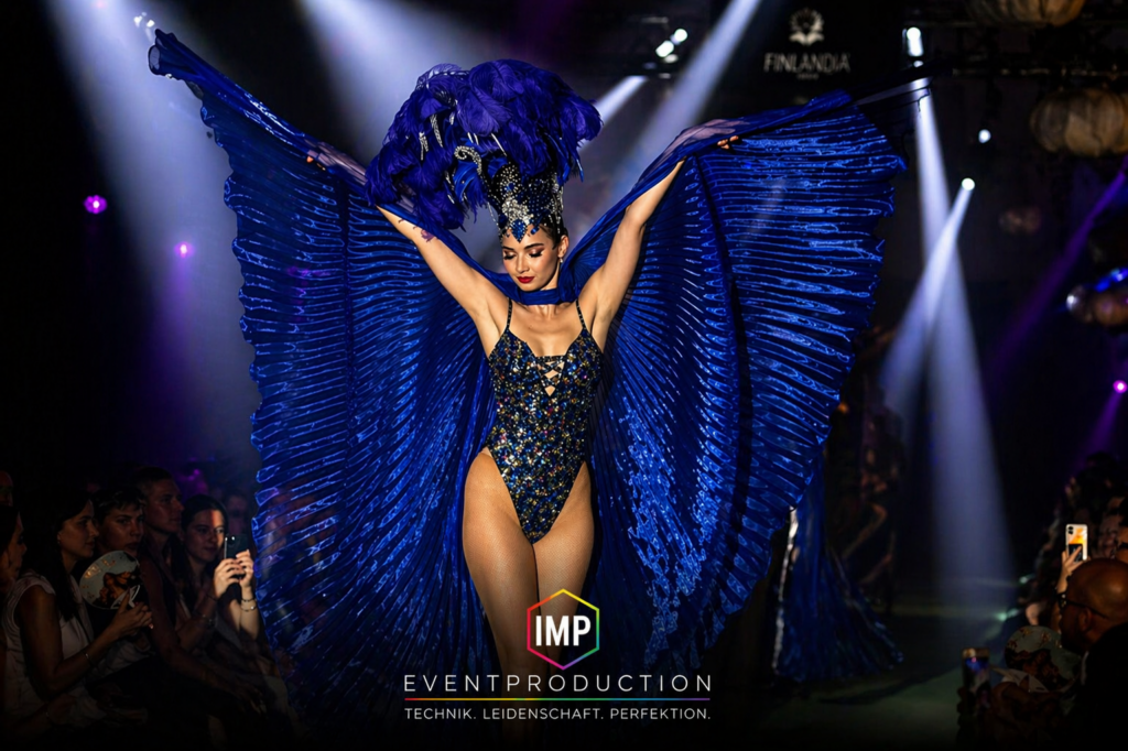 Showperformance auf Bühne mit spektakulärer Lichttechnik und Tänzerin in Kostüm – Eventtechnik von IMP Event Production
